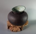 Hand built black clay vase with asymmetrical neck, turquoise glaze.